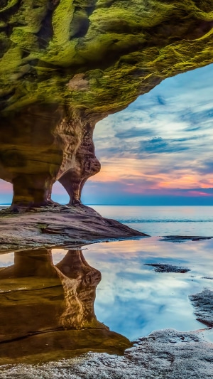 Cave entrance with reflection at sunrise