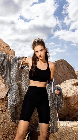 Barbara Palvin in black sportswear with a silver shawl