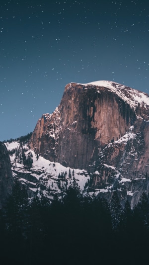 Half Dome mountain at night with stars