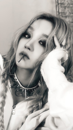 Yuqi from (G)I-DLE with a lollipop