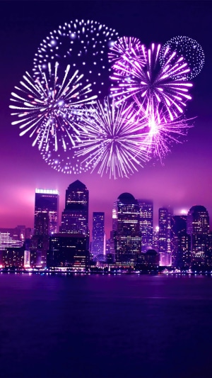 Fireworks over a city skyline at night