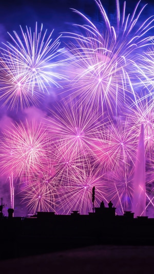 Fireworks over a city skyline at night