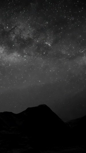 Night sky over silhouetted mountains