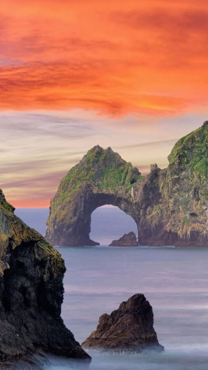 Arch Rock Formation in the Ocean at Sunset