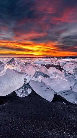 Icebergs on Black Sand Beach at Sunset