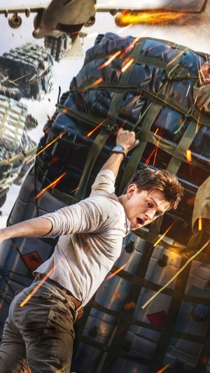 Nathan Drake from Uncharted hanging from cargo
