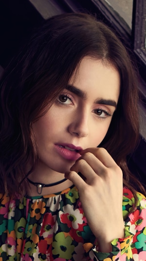 Lily Collins in a floral dress with a choker