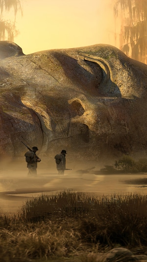 Two figures with rifles walk through a misty landscape near a large rock formation.