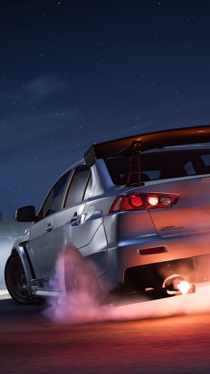 Mitsubishi Lancer Evolution X drifting at night