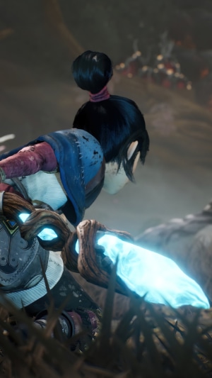 Kena from Kena: Bridge of Spirits holding a glowing staff