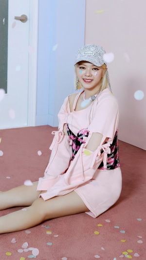 Jeongyeon from TWICE wearing a pink outfit and a cap