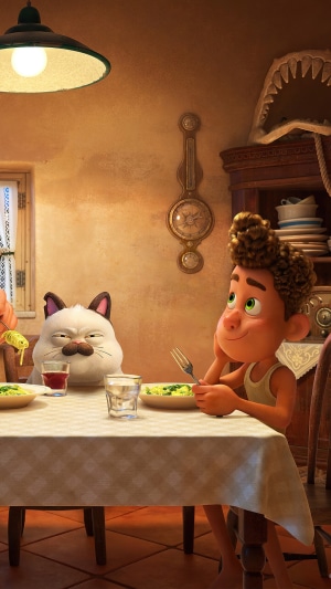 Luca and a cat eating at a table
