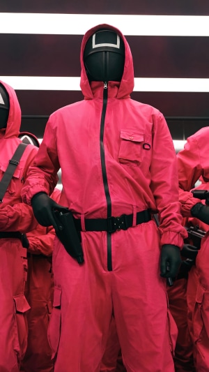 Squid Game guards in pink jumpsuits and masks