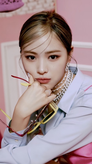 Ryujin from ITZY holding glasses
