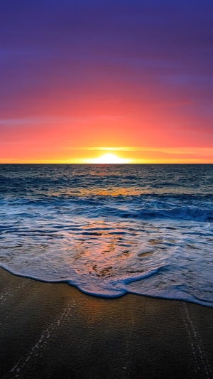 Sunset Over Ocean Horizon with Beach Waves
