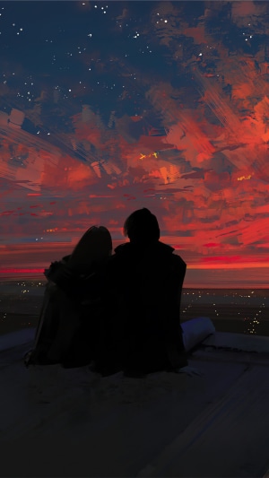 Couple watching a vibrant sunset over a city