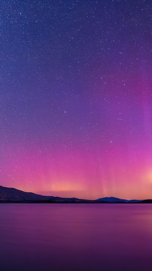 Aurora Borealis over a calm lake at night