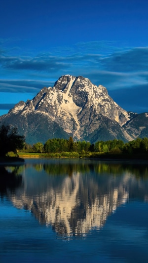 Snow-capped mountain reflected in a calm lake