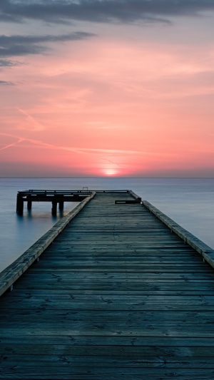 Wooden pier at sunset over the sea