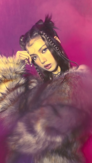 Lisa from BLACKPINK with braided hair and fur coat