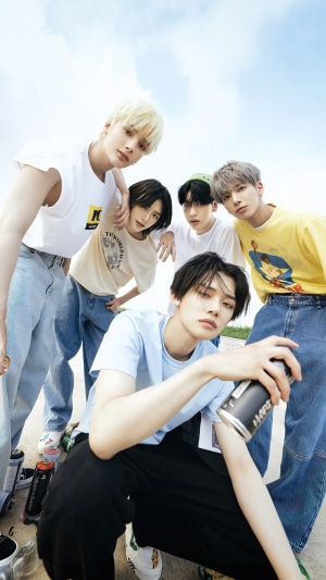 TXT members in casual outfits outdoors