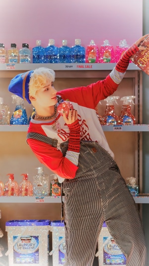Huening Kai from TXT holding a sparkly apple