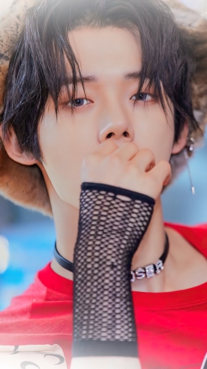 Yeonjun from TXT wearing a choker with 'LOSER' pendant