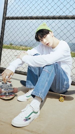 Soobin from TXT wearing a green beanie and jeans