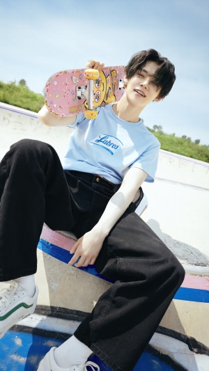 Yeonjun from TXT holding a skateboard