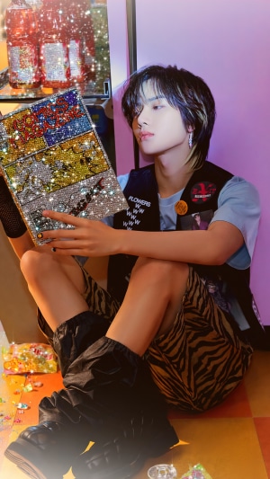 Choi Beomgyu from TXT holding a sparkly book