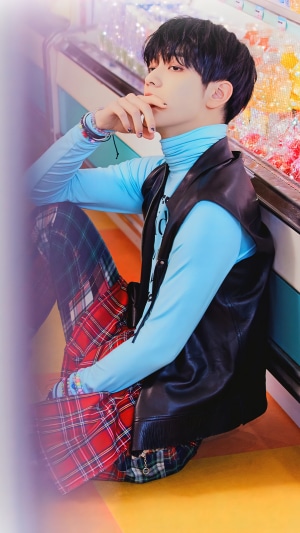 Soobin from TXT wearing a blue turtleneck and vest
