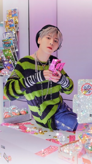 Taehyun from TXT holding pink items