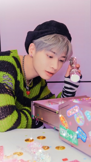 Taehyun from TXT holding a glittery object