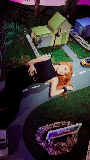 Seulgi from Red Velvet lying on a miniature road