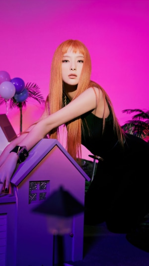 Seulgi from Red Velvet with orange hair and black dress