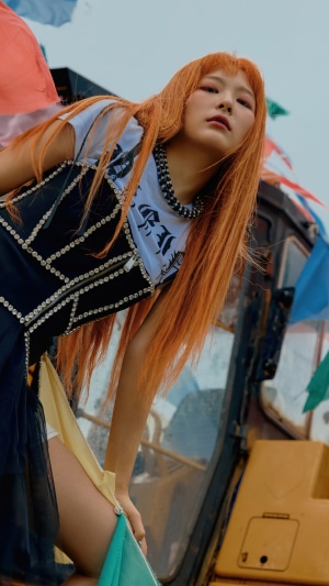 Seulgi from Red Velvet posing near a vehicle