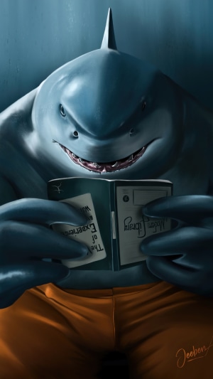 King Shark from The Suicide Squad reading a book