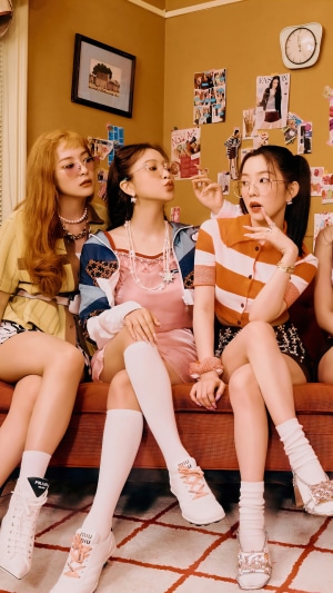 Red Velvet members Irene, Seulgi, and Wendy posing on a couch