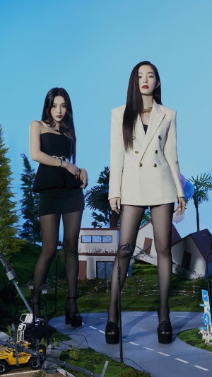 Red Velvet members Joy and Irene in a surreal outdoor setting