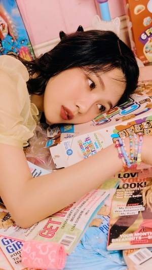 Joy from Red Velvet lying on magazines