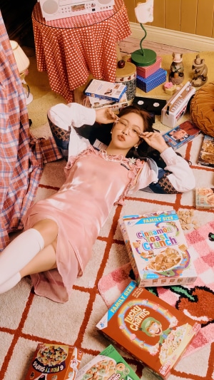 Yeri from Red Velvet lying on the floor with cereal boxes