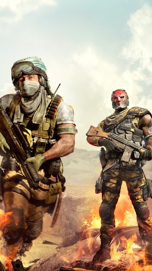 Two soldiers in a desert landscape with fire