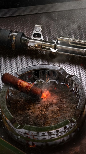 AK-47 rifle and burning cigar in ashtray