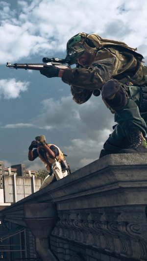 Soldiers aiming rifles on a building rooftop