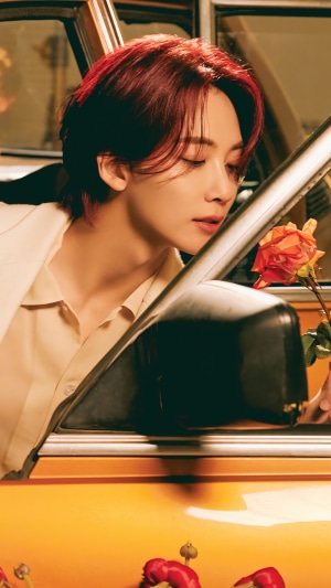 Jeonghan from Seventeen in a car with flowers