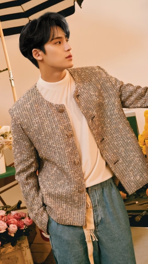 Mingyu from Seventeen wearing a tweed jacket and jeans