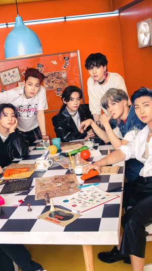 BTS members gathered around a table