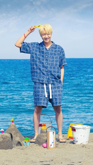 J-Hope from BTS on a beach with sandcastle