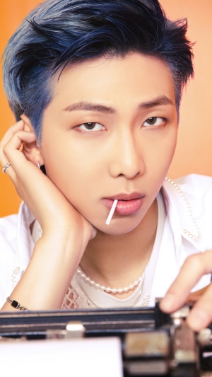 RM from BTS holding a lollipop