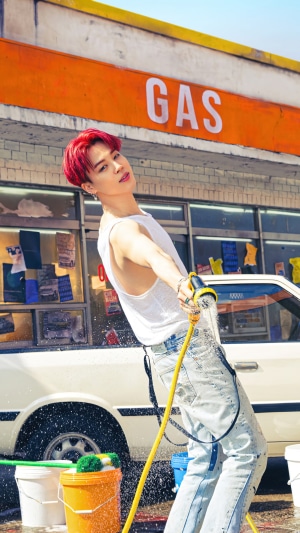 Jimin from BTS washing a car at a gas station